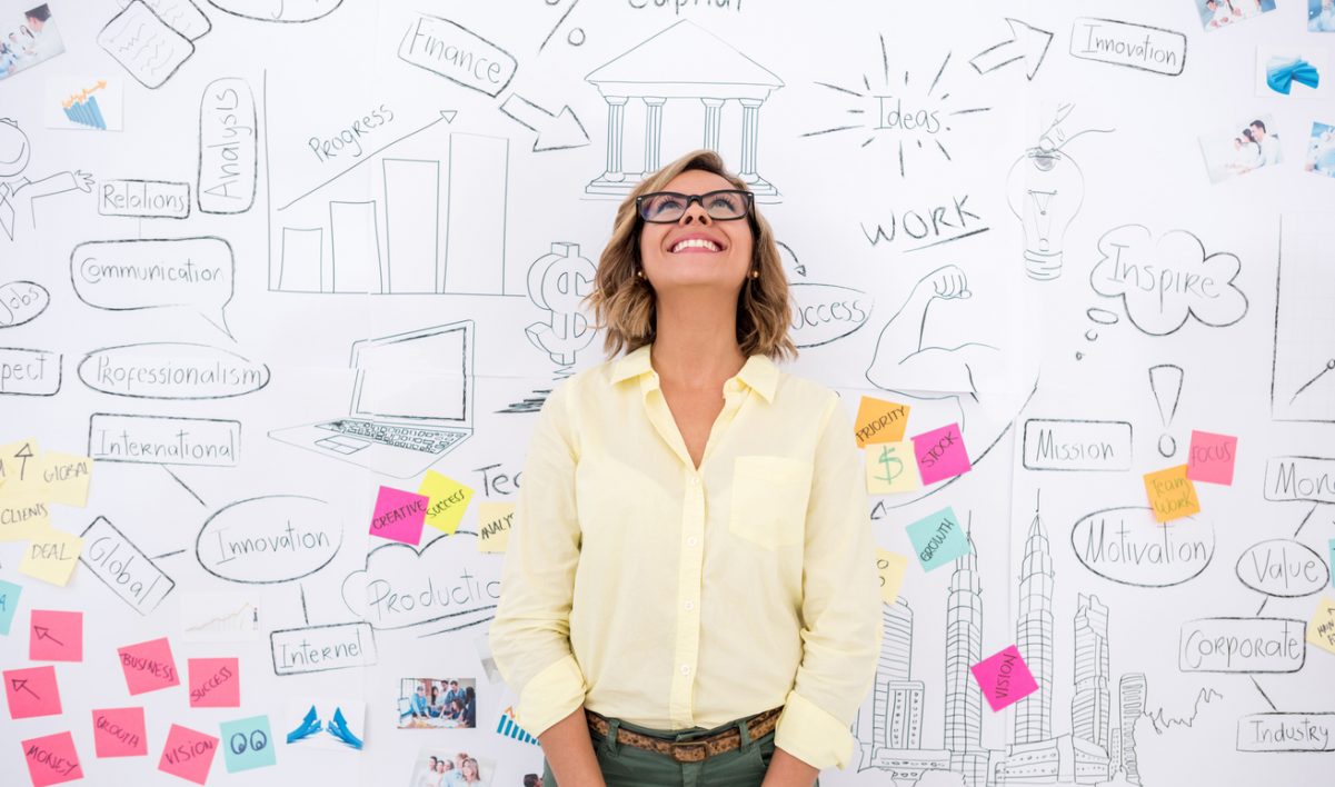 Creative business woman thinking Creative business woman thinking and brainstorming with a wall chart at the background